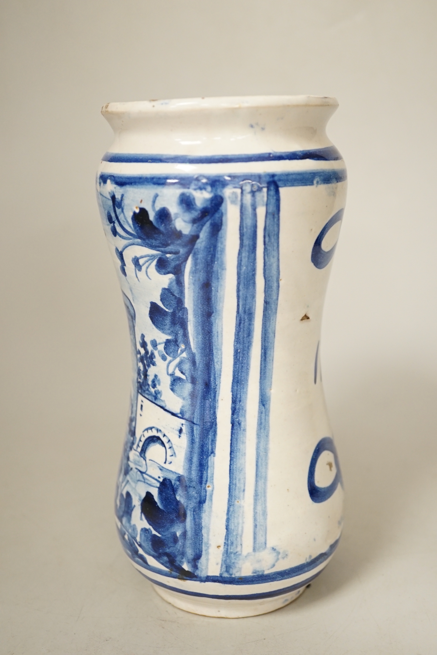 An Italian maiolica albarello, inscribed 1702, 20.5cm high